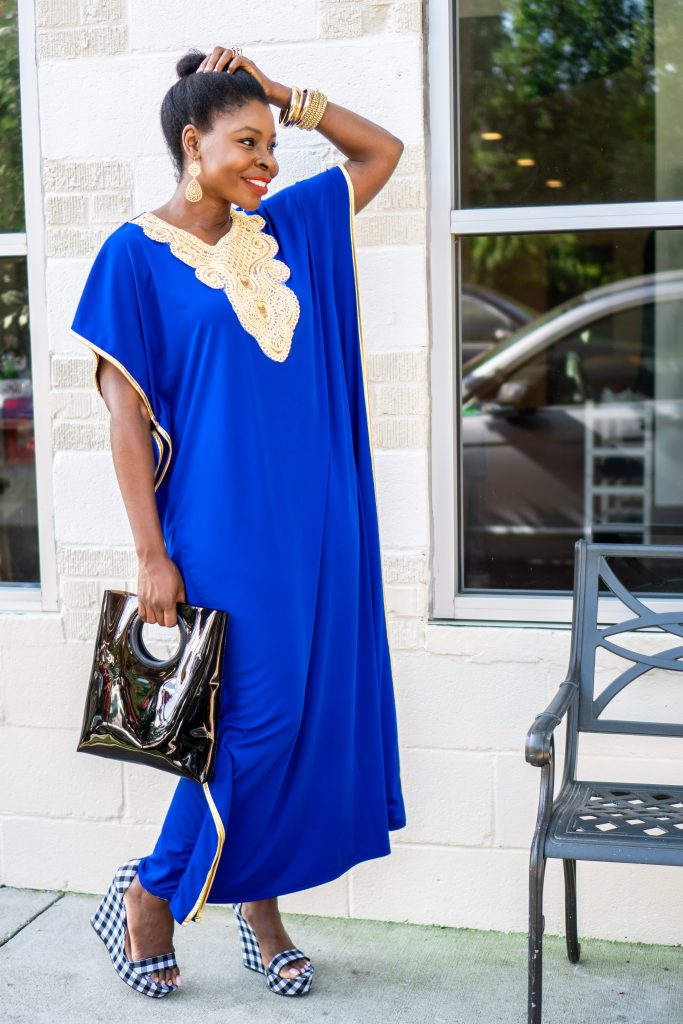 How to Wear an African Boubou, tips featured by top Atlanta fashion blogger, Hurry in Time: lady in blue boubou dress outside with her hand on her head