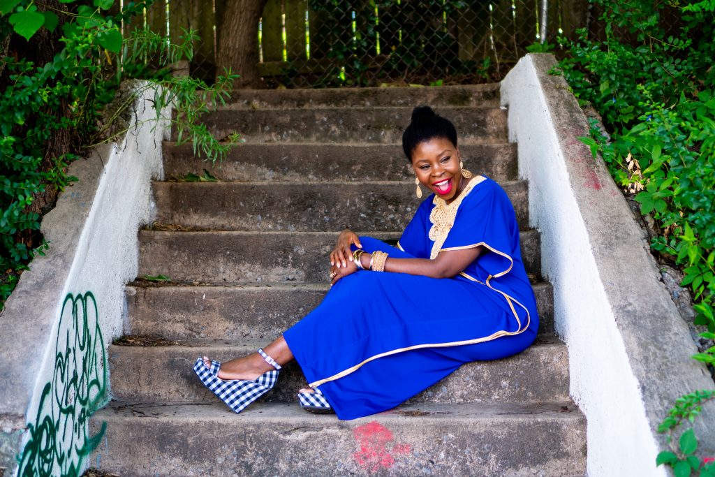 How to Wear an African Boubou, tips featured by top Atlanta fashion blogger, Hurry in Time: lady in blue boubou dress sitting on stairs outside