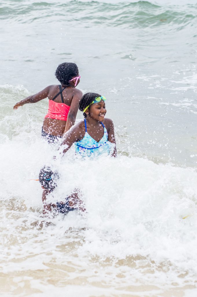 girls in rushing water on the beach