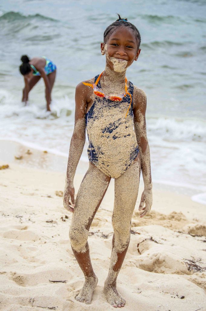 girl covered in sand