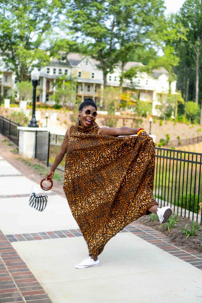 Herem Jumpsuit styled by top Atlanta fashion blogger, Hurry in Time: A woman wearing a animal print outfit and shades outside