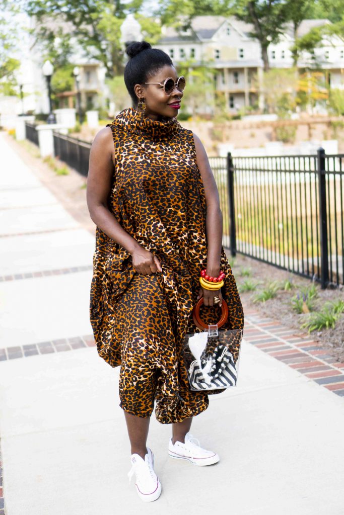 Herem Jumpsuit styled by top Atlanta fashion blogger, Hurry in Time: A woman wearing a animal print jumpsuit