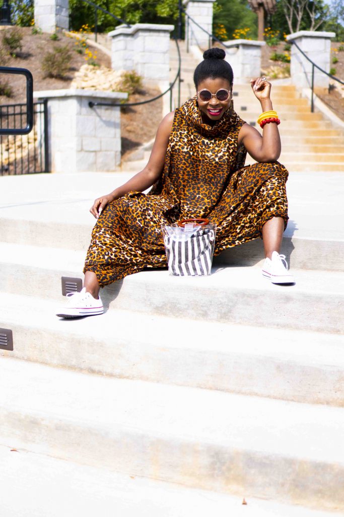 Herem Jumpsuit styled by top Atlanta fashion blogger, Hurry in Time: A woman wearing shades sitting on steps outside