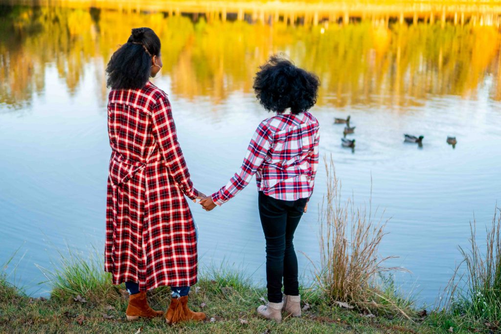 How to Address Family Nostalgia During the Holidays, tips featured by top Atlanta lifestyle blogger, Hurry in Time: Woman and girl holding hands standing near a pond watching ducks.