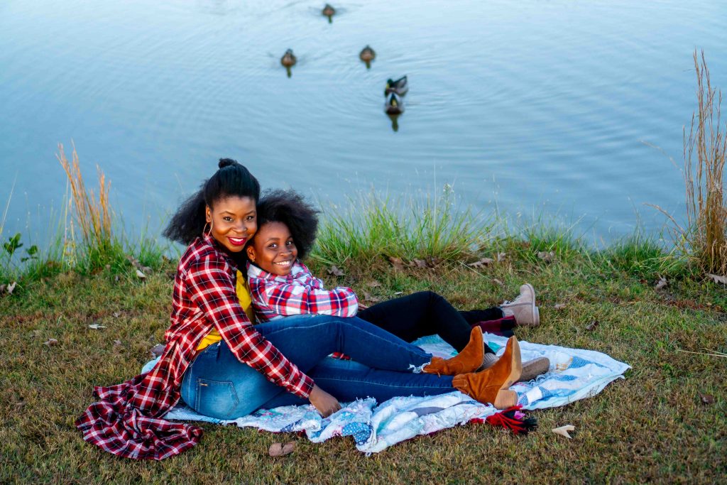 How to Address Family Nostalgia During the Holidays, tips featured by top Atlanta lifestyle blogger, Hurry in Time: Woman and girl sitting on a blanket in front of a pond.