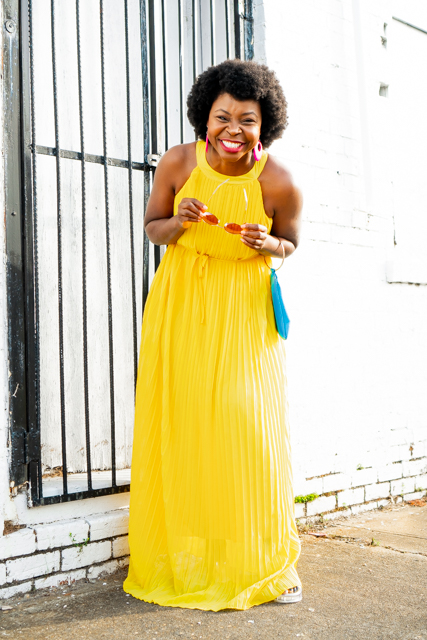 Yellow Pleated Dress styled for Summer by top Atlanta fashion blogger, Hurry in Time: Woman wearing a yellow dress smiling at the camera. 