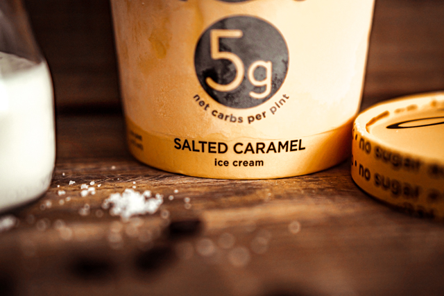 Keto Sea Salt Caramel Coffee Milkshake Recipe featured by top Atlanta lifestyle blogger, Hurry in Time: Rebel caramel ice cream on a wood table